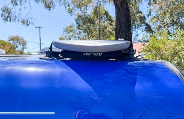 Close up of the removable roof rack on Caravan with surfboard installed